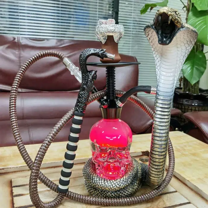 Decorative hookah tobacco pipe with ornate base and glass water chamber
