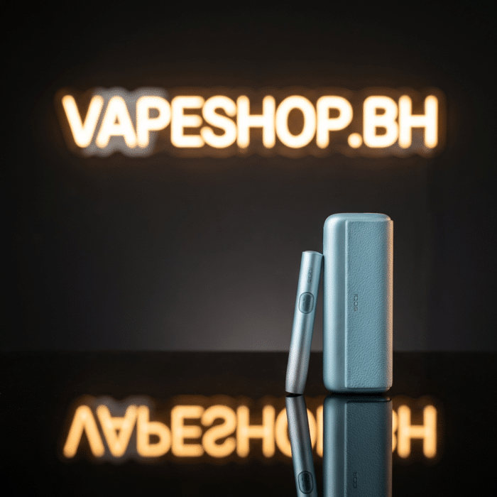 Silver iqos iluma i in use with stick, induction heating chamber, portable for bahrain on-the-go.