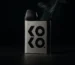 Uwell Caliburn Koko pod system with vapor wisps in dramatic lighting
