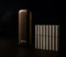IQOS ORIGINALS device with HEETS heated tobacco sticks on a dark background