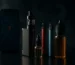 Hero image for محل فيب قريب مني في البحرين: smartphone search for a vape shop with vape products and vapor in a dark studio scene